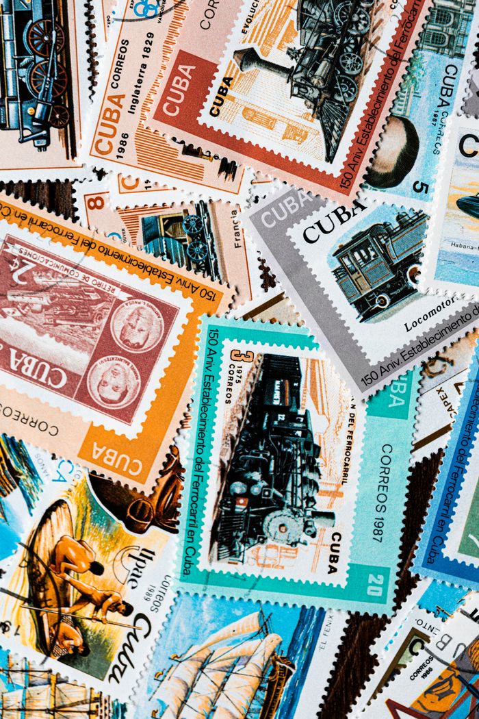An artistic array of Cuban postage stamps featuring vintage designs and historical themes.