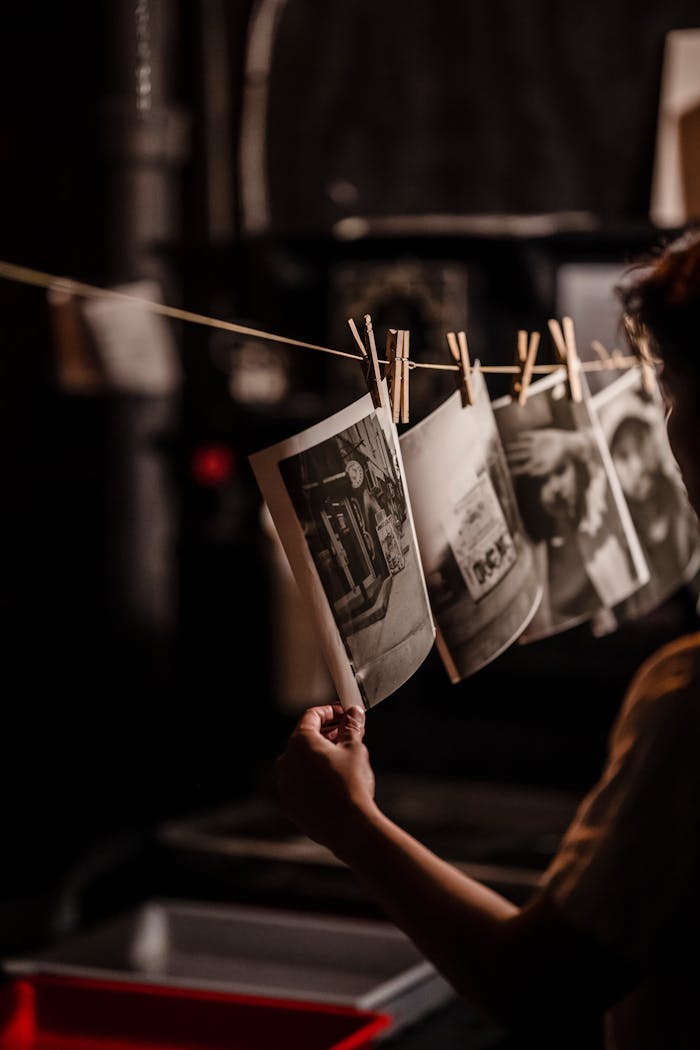 services-img Black and white photographs drying in a darkroom setting with vintage process.